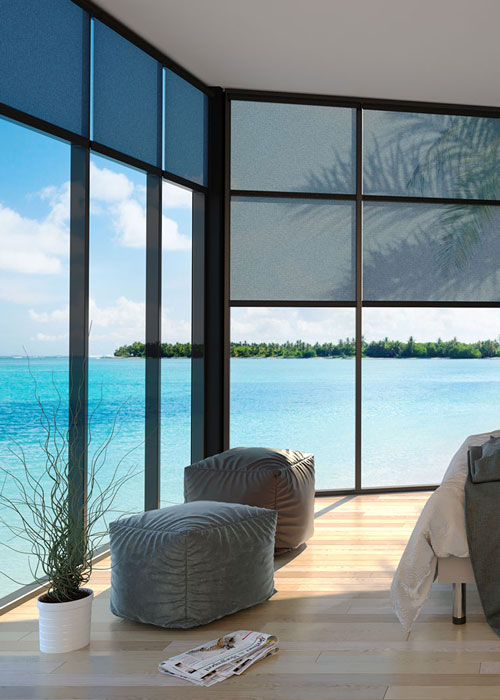 Windows with an ocean view and motorized shades.