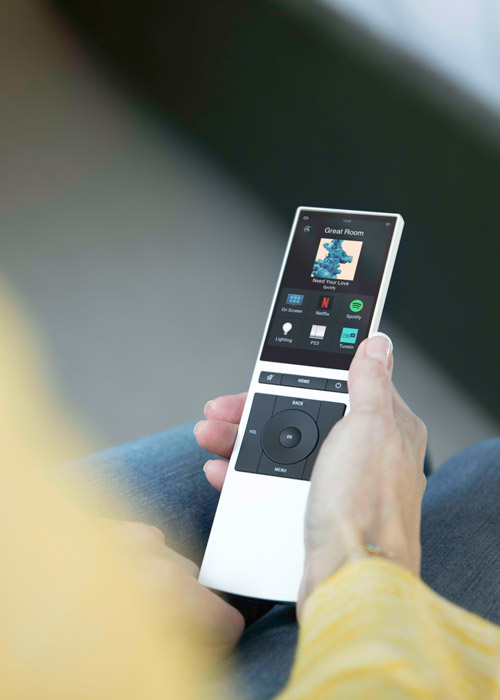 Hand holding the Control4 remote. 