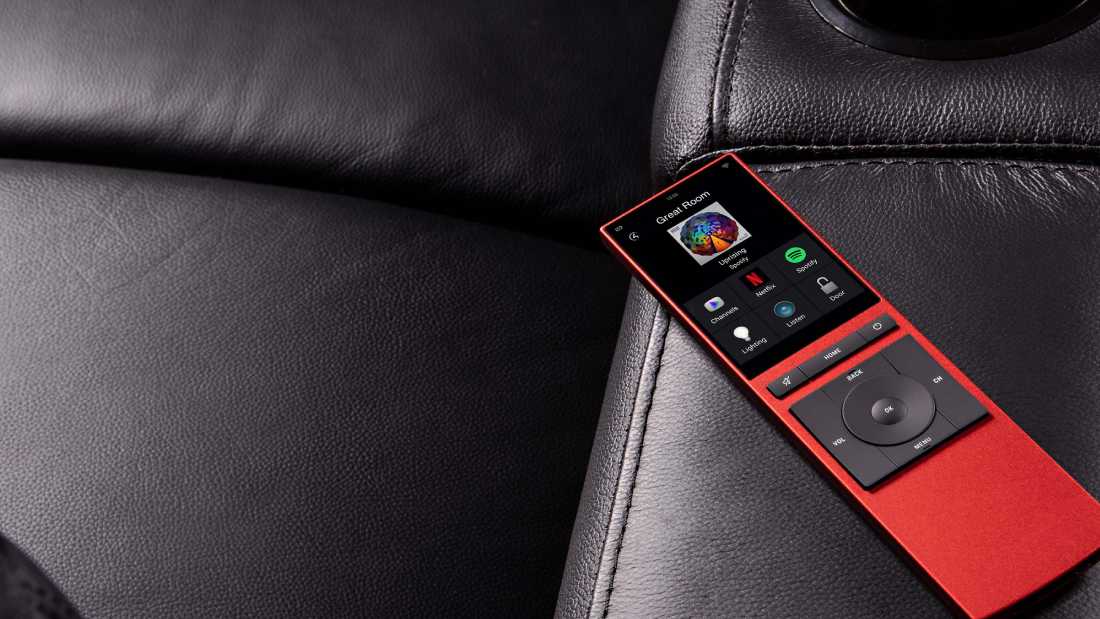 Control4 red controller on top of a couch