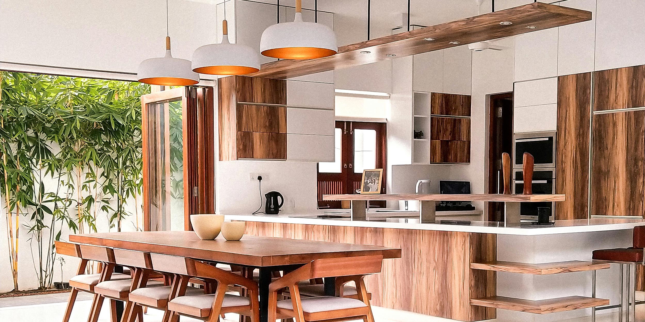 Modern open kitchen and dining area with wood and white accents
