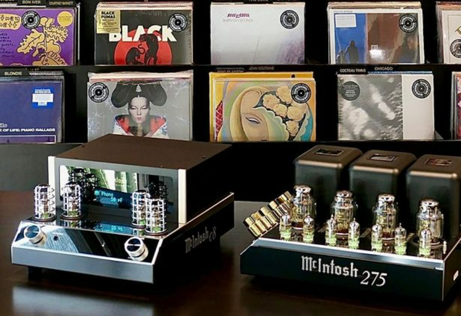 A pair of McIntosh amplifiers overseeing vinyl records.