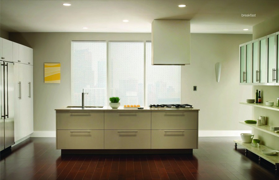 A kitchen featuring Lutron recessed lights and motorized shades. 