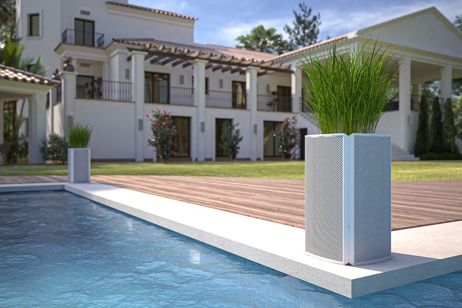 Coastal Source Razor speakers camouflage as planters next to a pool setting