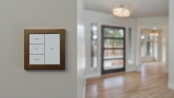Smart light switch panel with labeled scene controls on wall