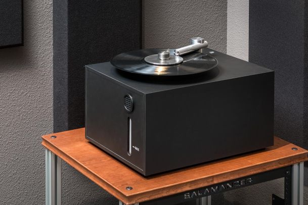 Vinyl record cleaning machine on wooden audio rack