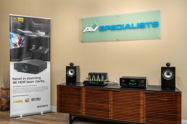 Audio display with speakers, amplifier, and AV Specialists signage