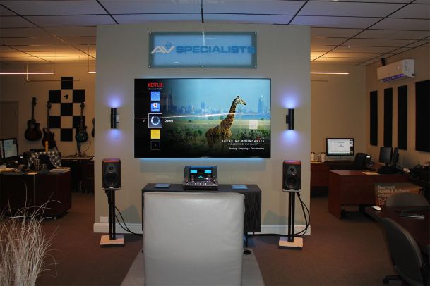 Demo area with AV Specialists sign, TV display, and speaker setup