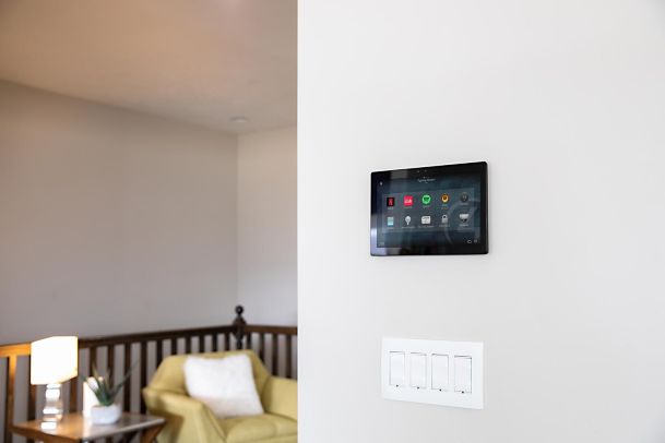 Wall-mounted smart home control panel in living space