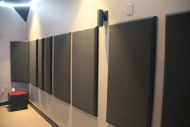 Acoustic wall panels inside dedicated home theater room