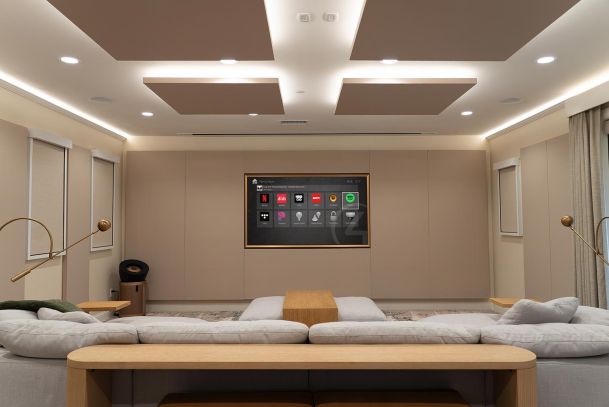 Home theater with wall-mounted screen and large sectional sofa