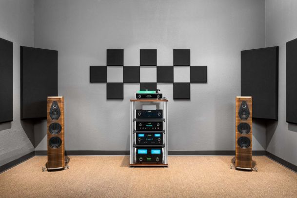High-end audio system with wooden floor speakers and acoustic panels